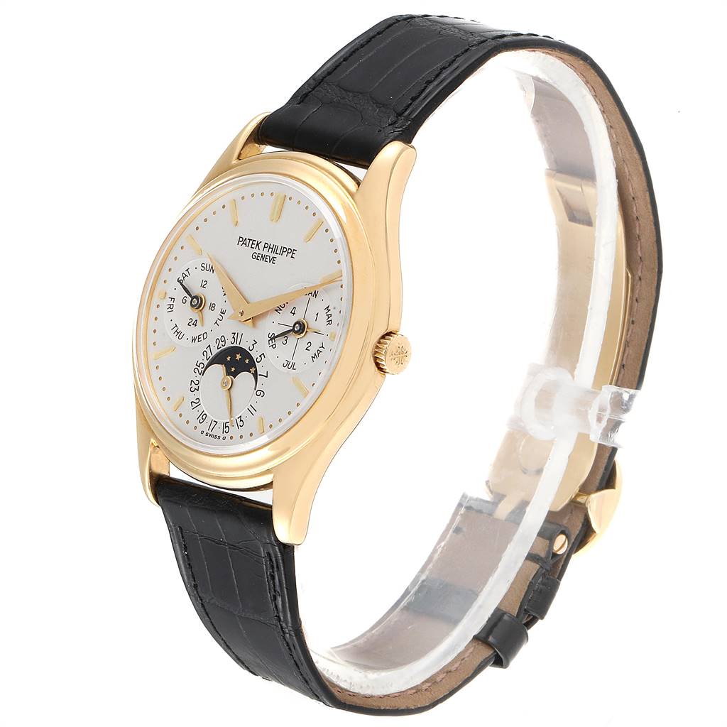 This image shows a side angle of the Patek Philippe 3940 Men's Yellow Gold Silver Dial 3940 Men's Yellow Gold Silver Dial Perpetual Calendar 18K Yellow Gold Watch 3940 with a leather strap and a detailed dial.