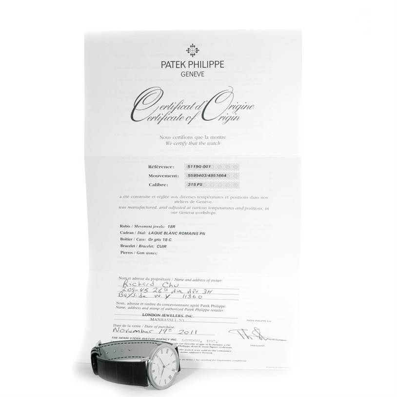The image shows a Patek Philippe Calatrava 5119G Men's White Gold White Dial 5119G Men's White Gold White Dial watch placed beneath its Certificate of Origin, viewed from a frontal angle.