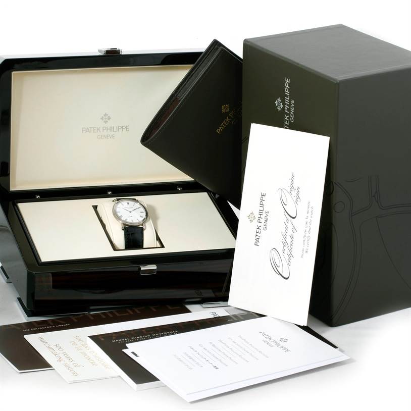 The Patek Philippe Calatrava 5119G Men's White Gold White Dial 5119G Men's White Gold White Dial watch is displayed front-on in a box with accompanying documents and accessories.