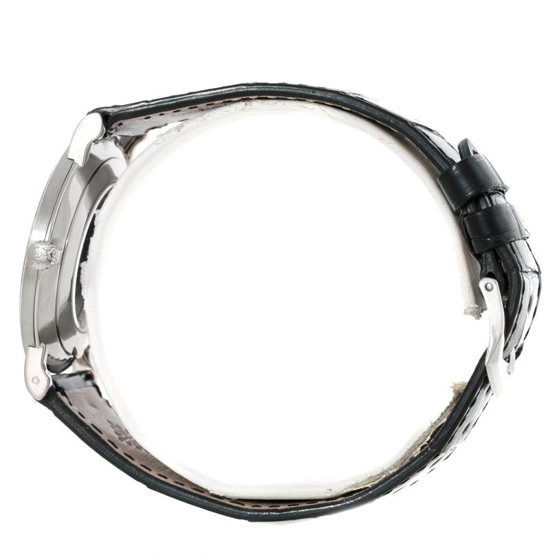 The image shows a side view of a Patek Philippe Calatrava 5119G Men's White Gold White Dial 5119G Men's White Gold White Dial watch, focusing on its case, crown, and leather strap with a buckle.