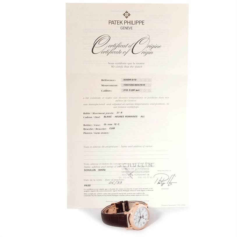 The image shows a Patek Philippe 5059R Men
s Rose Gold White Dial 5059R Men
s Rose Gold White Dial Perpetual Calendar Retrograde 18k Rose Gold Watch 5059R model at a slight angle with its certificate of origin.