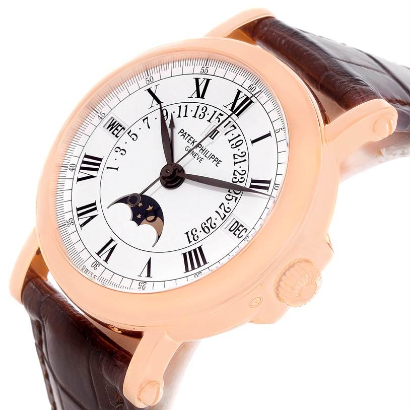 The watch is a Patek Philippe 5059R Men
s Rose Gold White Dial 5059R Men
s Rose Gold White Dial Perpetual Calendar Retrograde 18k Rose Gold 5059R, shown at an angle highlighting the dial and crown.