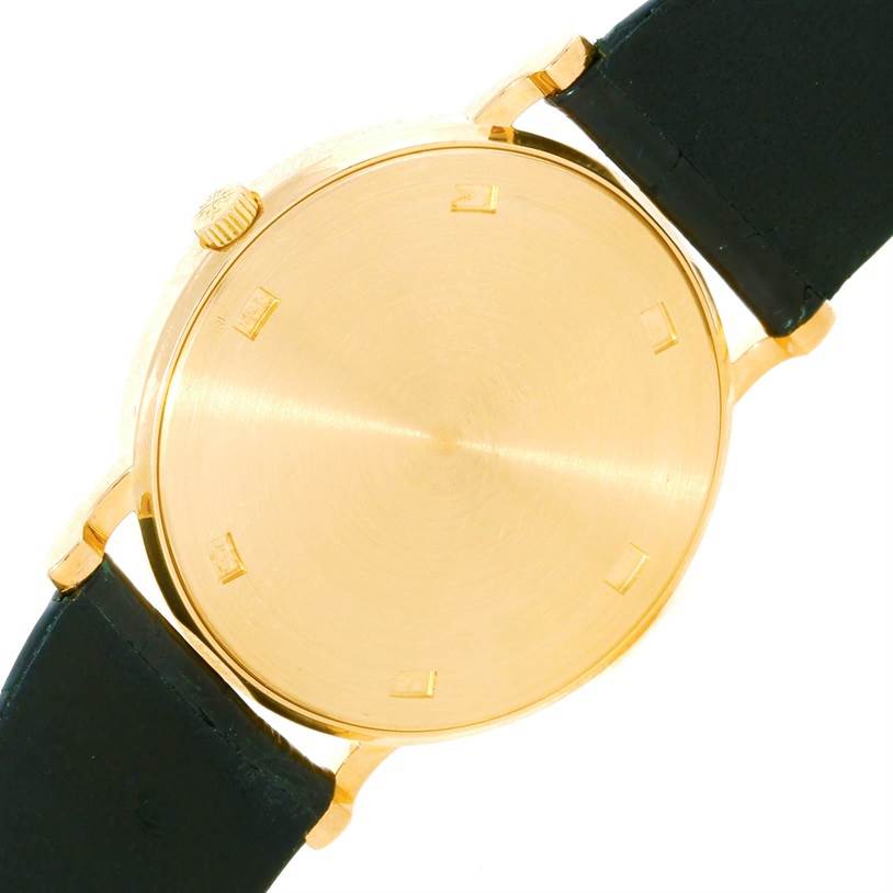 The image shows the back and side of the case and black leather strap of a Patek Philippe Calatrava 3520 Men's Yellow Gold White Dial 3520 Men's Yellow Gold White Dial watch.