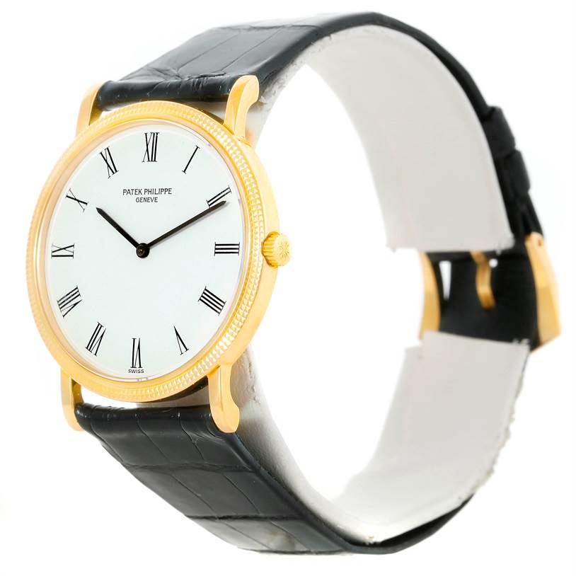The image shows a Patek Philippe Calatrava 3520 Men's Yellow Gold White Dial 3520 Men's Yellow Gold White Dial watch at a slight side angle, highlighting its gold case, Roman numeral dial, and black leather strap.