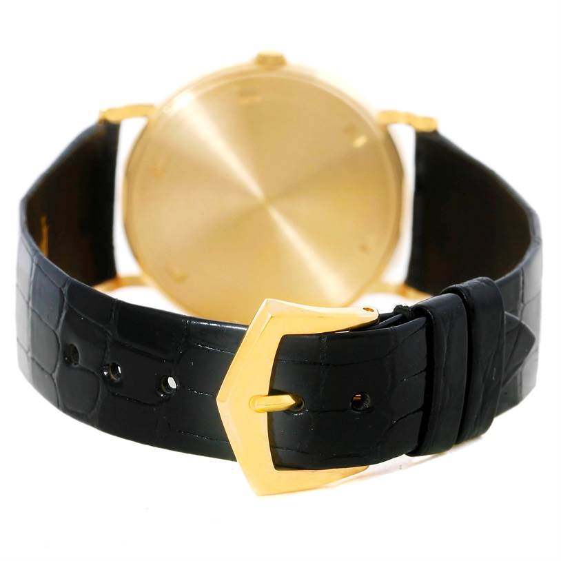 The image shows the back of a Patek Philippe Calatrava 3520 Men's Yellow Gold White Dial 3520 Men's Yellow Gold White Dial watch, featuring its gold case and black leather strap.