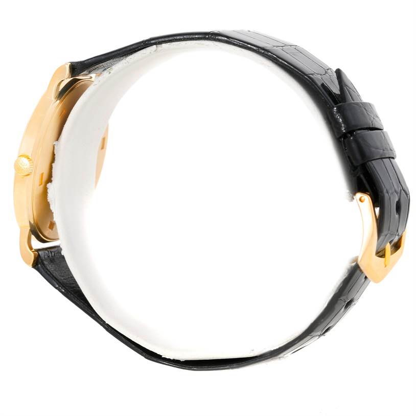 This image shows a side view of the Patek Philippe Calatrava 3520 Men's Yellow Gold White Dial 3520 Men's Yellow Gold White Dial watch, highlighting the case, crown, and black leather strap with a gold buckle.