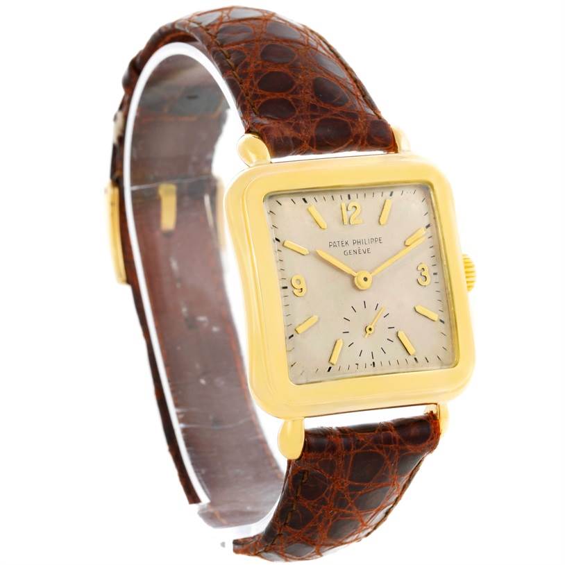The image shows a Patek Philippe Vintage 2493 Men's Yellow Gold Silver Dial 2493 Men's Yellow Gold Silver Dial model watch from an angled side view, highlighting the gold case and brown leather strap.