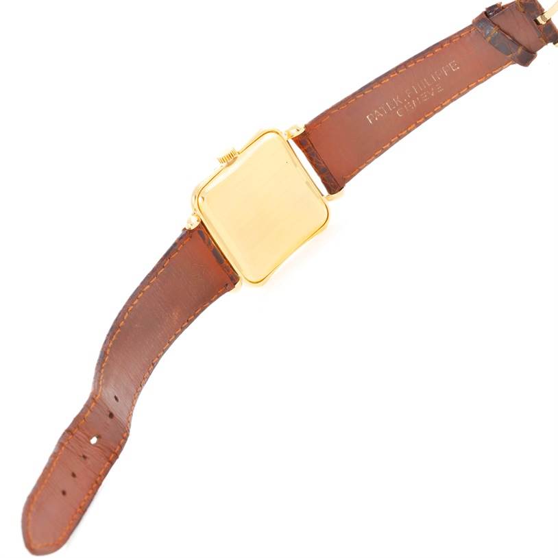 This image shows the back of a Vintage Patek Philippe watch with a brown leather strap.