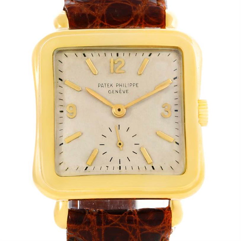 The image shows the front view of a Vintage Patek Philippe watch, highlighting its square face, gold case, and brown leather strap.