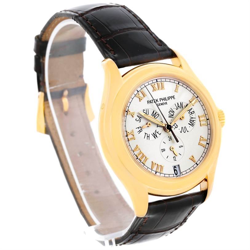 The image shows a Patek Philippe Complications 5035R Men
s Yellow Gold Silver Dial 5035R Men
s Yellow Gold Silver Dial watch at a three-quarter angle, highlighting the face, bezel, and leather strap.