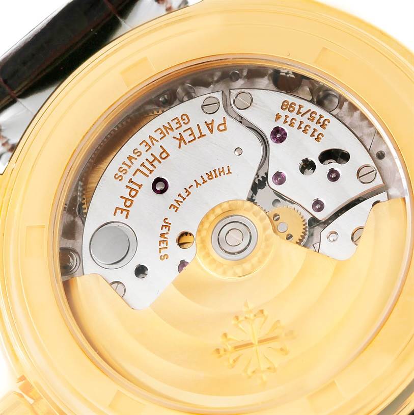 The image shows the movement and internal mechanical parts of a Patek Philippe Complications 5035R Men
s Yellow Gold Silver Dial 5035R Men
s Yellow Gold Silver Dial model watch from the back.