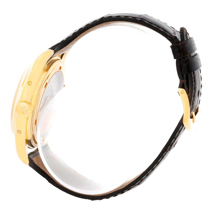 The image shows a side view of a Patek Philippe Complications 5035R Men
s Yellow Gold Silver Dial 5035R Men
s Yellow Gold Silver Dial watch, highlighting the crown, case, and leather strap.