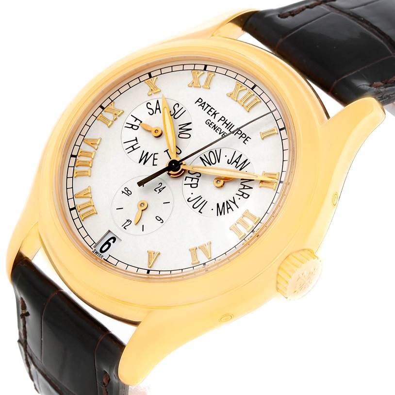 The image shows a close-up angle of the Patek Philippe Complications 5035R Men
s Yellow Gold Silver Dial 5035R Men
s Yellow Gold Silver Dial watch, highlighting its white dial, Roman numeral markers, and leather strap.