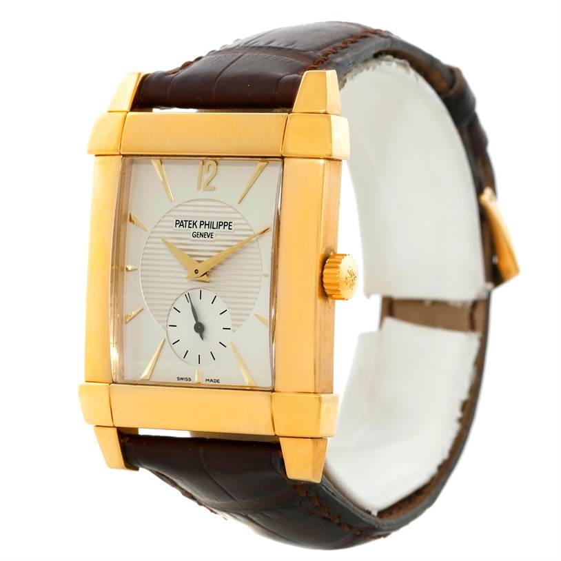 The image shows a Patek Philippe Gondolo 5111J Men's Yellow Gold Silver Dial 5111J Men's Yellow Gold Silver Dial watch from an angled front view, highlighting the face, crown, and part of the leather strap.