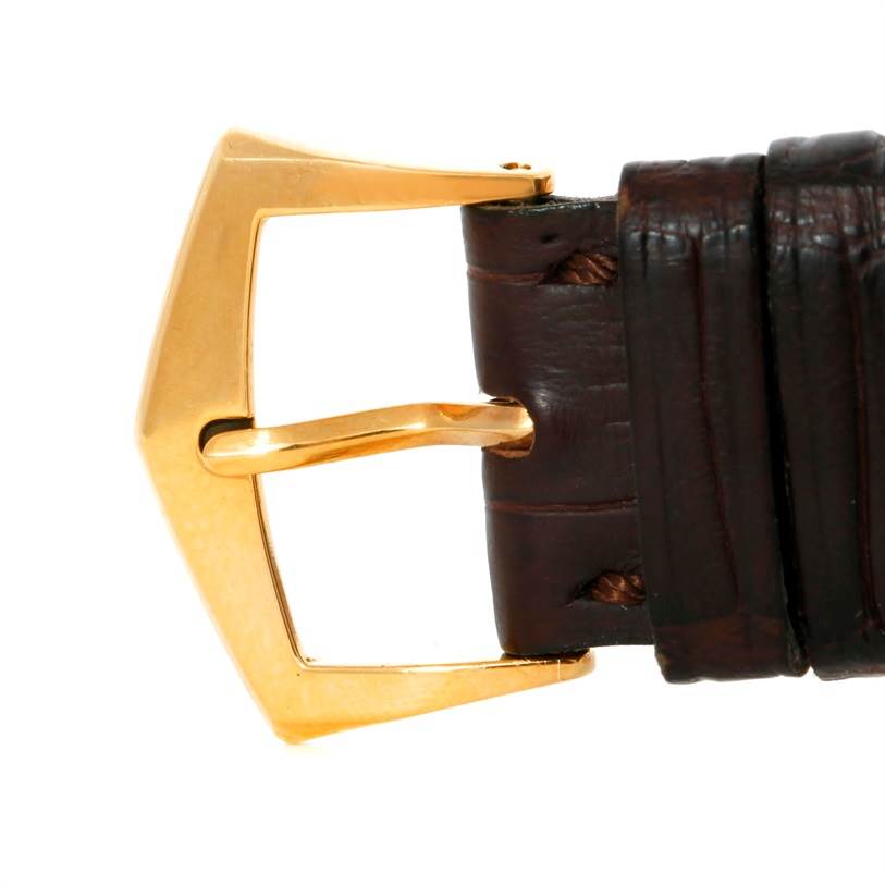 This is a close-up view of the gold buckle and brown leather strap of a Patek Philippe Gondolo 5111J Men's Yellow Gold Silver Dial 5111J Men's Yellow Gold Silver Dial watch.