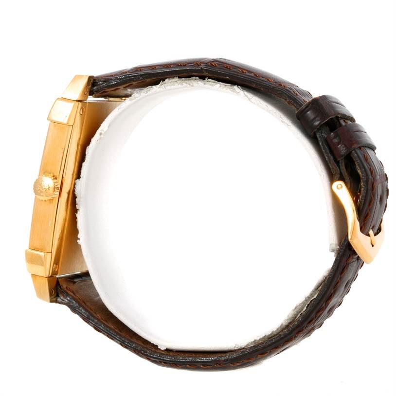 The image shows a side view of a Patek Philippe Gondolo 5111J Men's Yellow Gold Silver Dial 5111J Men's Yellow Gold Silver Dial watch, highlighting its case, crown, and leather strap with a buckle.