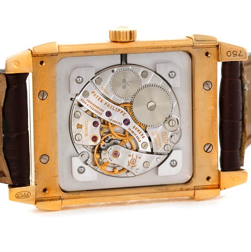 The image shows the back view of the Patek Philippe Gondolo 5111J Men's Yellow Gold Silver Dial 5111J Men's Yellow Gold Silver Dial watch, revealing its intricate mechanical movement.