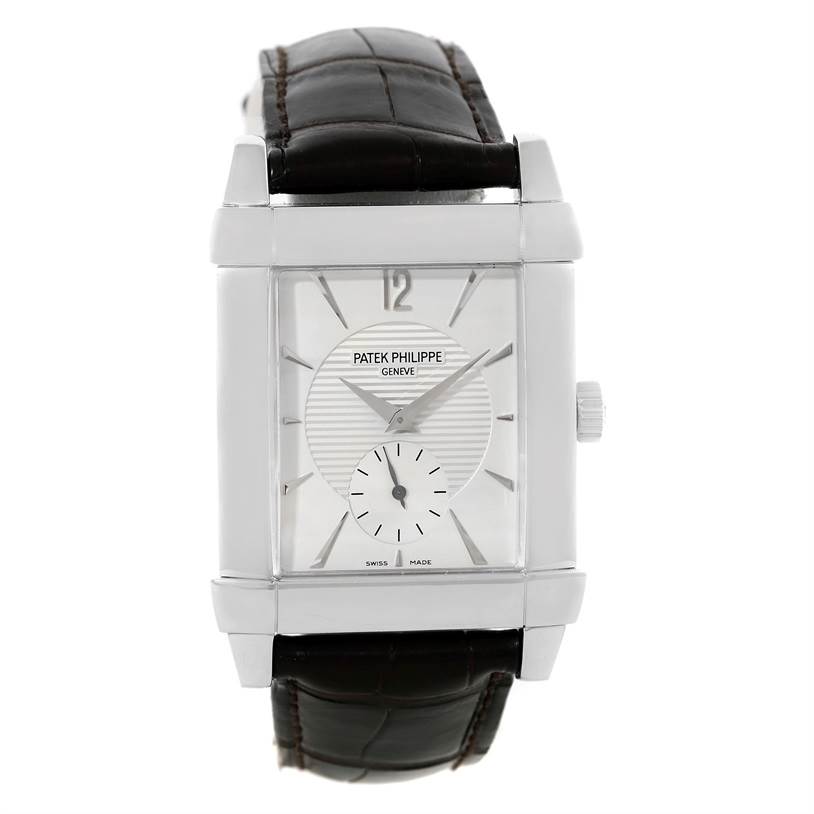 The Patek Philippe Gondolo 5111G Men's White Gold Silver Dial 5111G Men's White Gold Silver Dial watch is shown from a front angle, displaying its rectangular face, dial, and black leather strap.