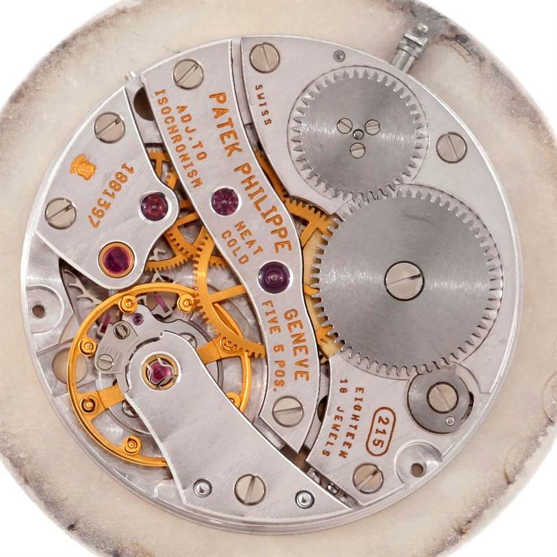 This image shows the intricate internal movement of the Patek Philippe Calatrava 3919 Men's Yellow Gold White Dial 3919 Men's Yellow Gold White Dial watch, highlighting gears and components.