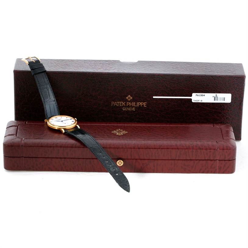 The image shows a Patek Philippe Calatrava 3919 Men's Yellow Gold White Dial 3919 Men's Yellow Gold White Dial watch resting on its opened, maroon leather case with the outer box in the background.
