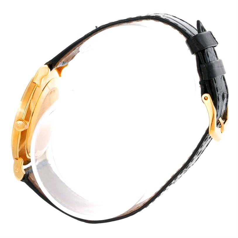 The image shows a side profile view of the Patek Philippe Calatrava 3919 Men's Yellow Gold White Dial 3919 Men's Yellow Gold White Dial watch, featuring its case, crown, and leather strap with a buckle.