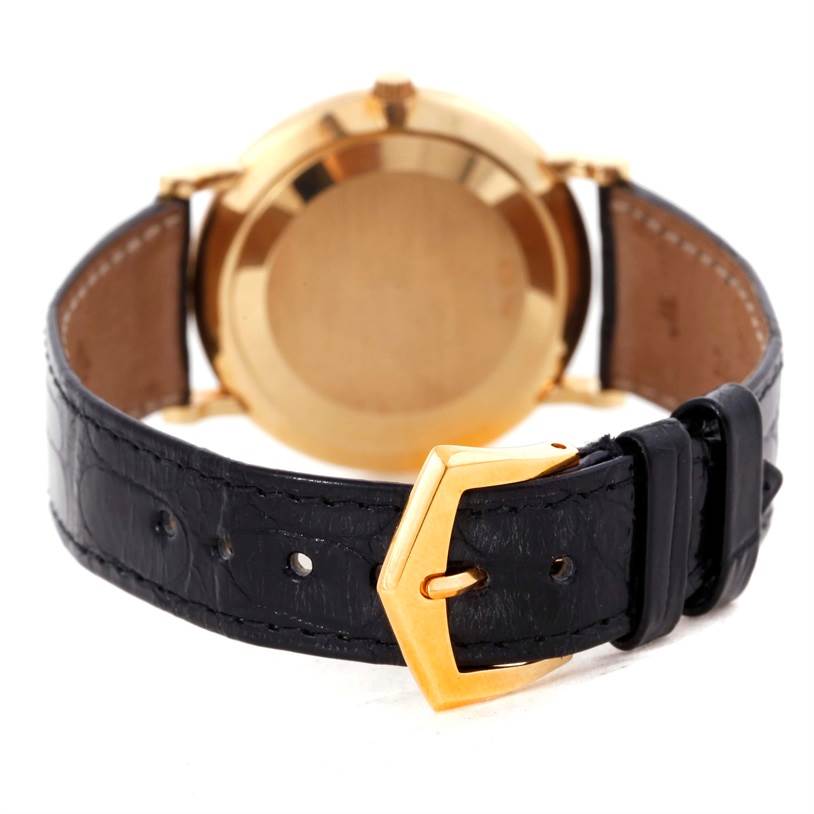 This image shows the back view of a Patek Philippe Calatrava 3919 Men's Yellow Gold White Dial 3919 Men's Yellow Gold White Dial watch, focusing on the gold case, clasp, and black leather strap.