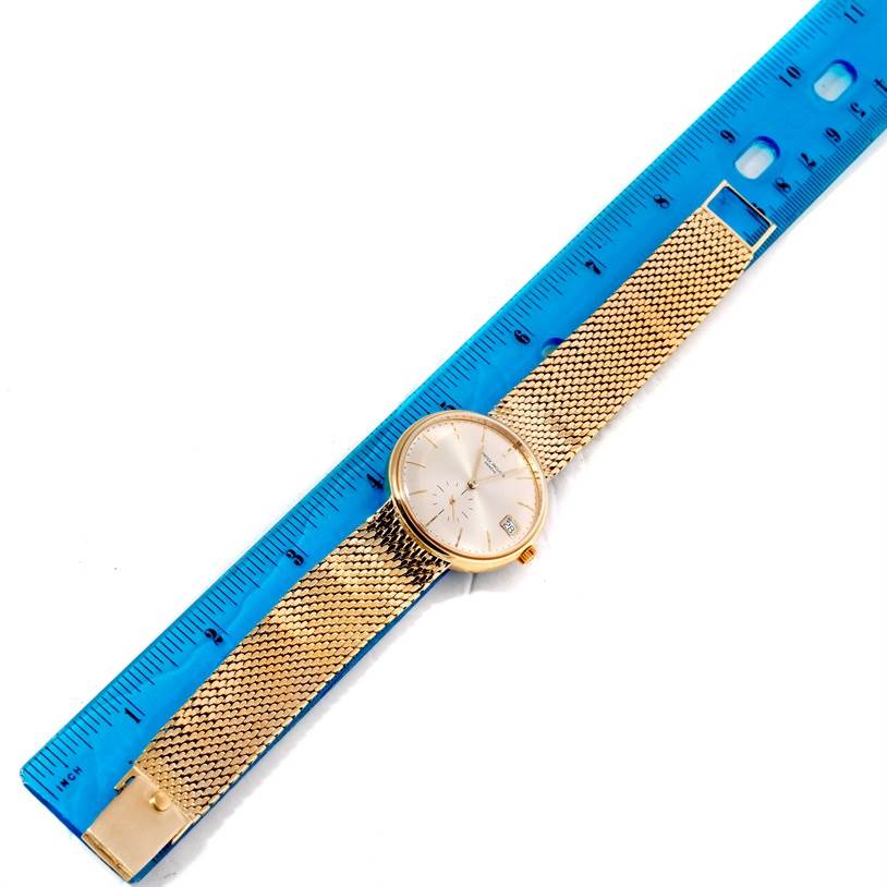 The image shows a Vintage Patek Philippe watch laid flat next to a blue ruler for size reference.
