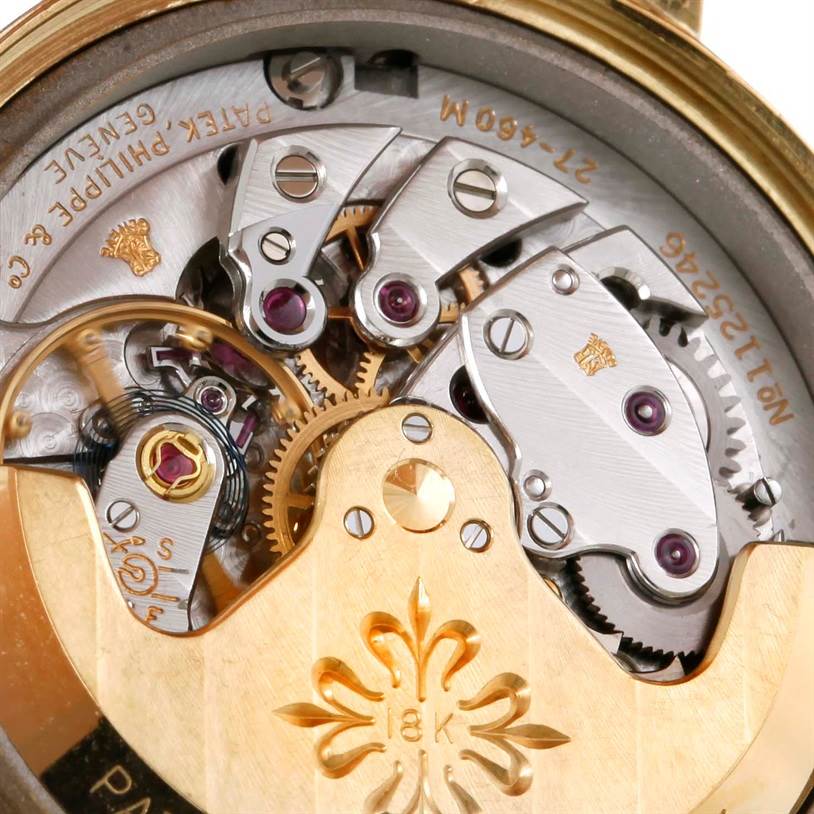 The image shows the intricate movement and internal mechanism of a Vintage Patek Philippe watch.