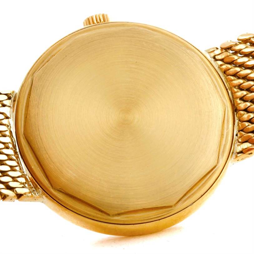 The image shows the back case and part of the bracelet of a Vintage Patek Philippe watch, viewed from above.