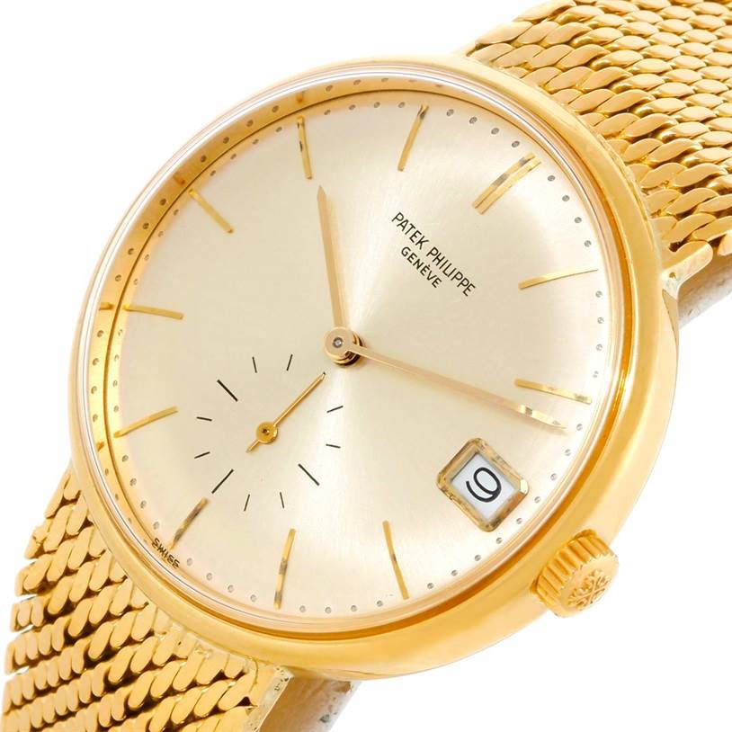 The image shows a Vintage Patek Philippe watch at an oblique angle, displaying its face, hands, crown, and part of the metallic strap.