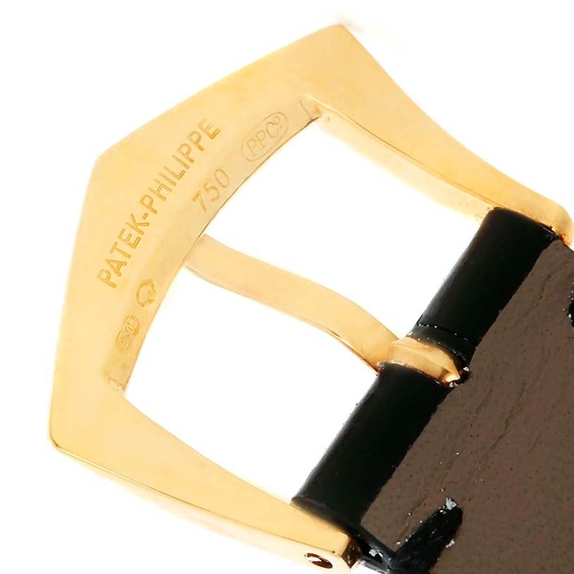 This image shows a close-up of the gold buckle of a Patek Philippe Calatrava 3802 Men's Yellow Gold White Dial 3802 Men's Yellow Gold White Dial watch strap.