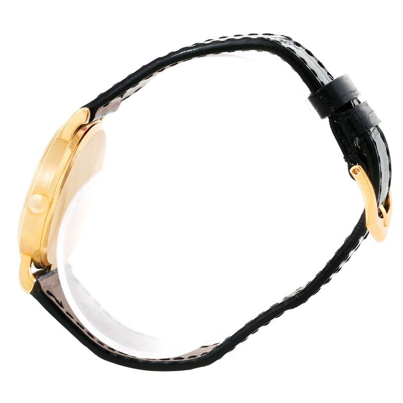 This image shows a side view of the Patek Philippe Calatrava 3802 Men's Yellow Gold White Dial 3802 Men's Yellow Gold White Dial watch, highlighting its gold case and black leather strap.