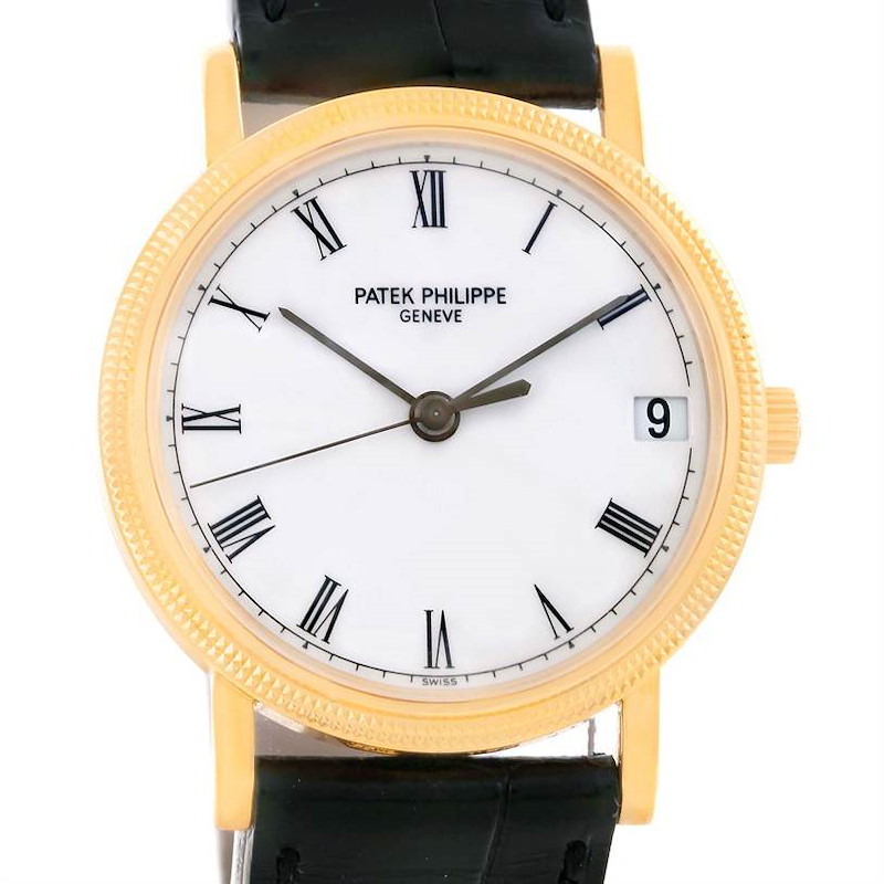 The Patek Philippe Calatrava watch is shown from a front angle, displaying its face, Roman numerals, and black leather strap.