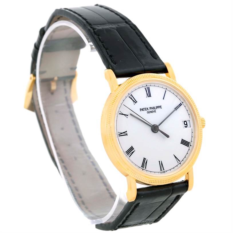 The Patek Philippe Calatrava 3802 Men's Yellow Gold White Dial 3802 Men's Yellow Gold White Dial watch is shown at a slight angle, highlighting the face, bezel, and leather strap.