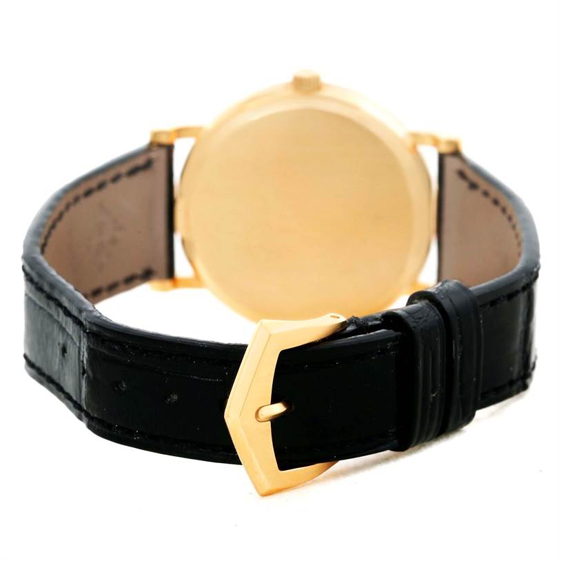 The image shows the back view of a Patek Philippe Calatrava 3802 Men's Yellow Gold White Dial 3802 Men's Yellow Gold White Dial watch, highlighting the leather strap and gold buckle.