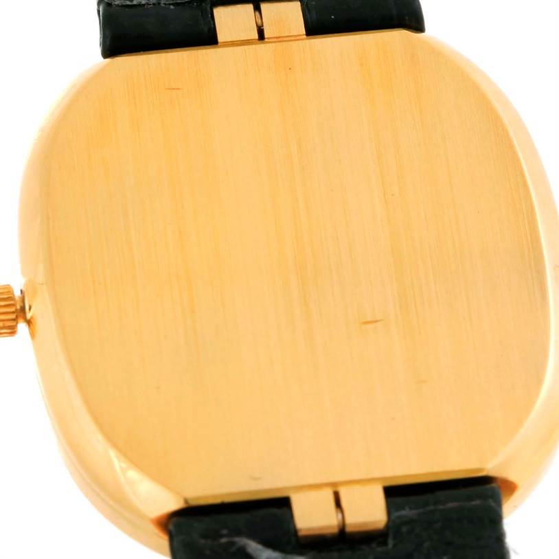 This image shows the back case of the Patek Philippe Golden Ellipse 3738 Men's Yellow Gold Blue Dial 3738 Men's Yellow Gold Blue Dial watch at a slight angle, including parts of the strap and the crown.