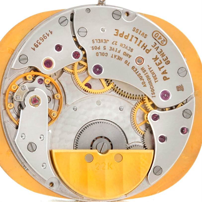 This is an image of the movement mechanism of the Patek Philippe Golden Ellipse 3738 Men's Yellow Gold Blue Dial 3738 Men's Yellow Gold Blue Dial watch, showing gears, jewels, and engravings.