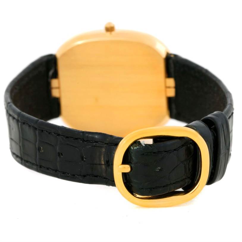 The image shows the back of a Patek Philippe Golden Ellipse 3738 Men's Yellow Gold Blue Dial 3738 Men's Yellow Gold Blue Dial watch, highlighting its gold case and black leather strap with a golden buckle.