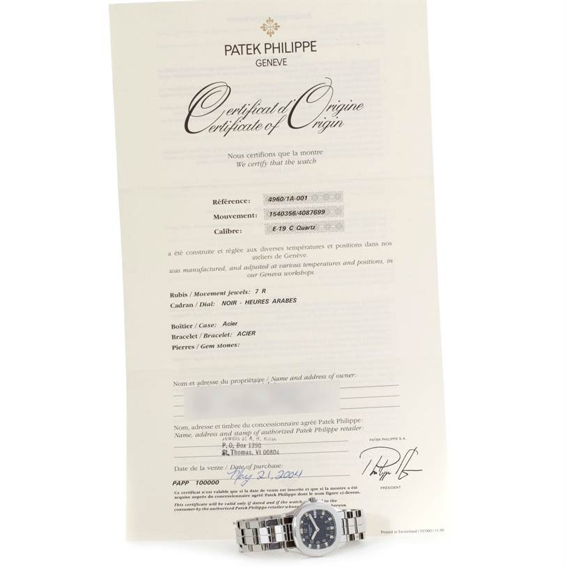 The image shows a Patek Philippe Aquanaut 4960/1A-001 Women's Stainless Steel Black Dial 4960/1A-001 Women's Stainless Steel Black Dial watch placed in front of its Certificate of Origin, displayed at a slight angle.