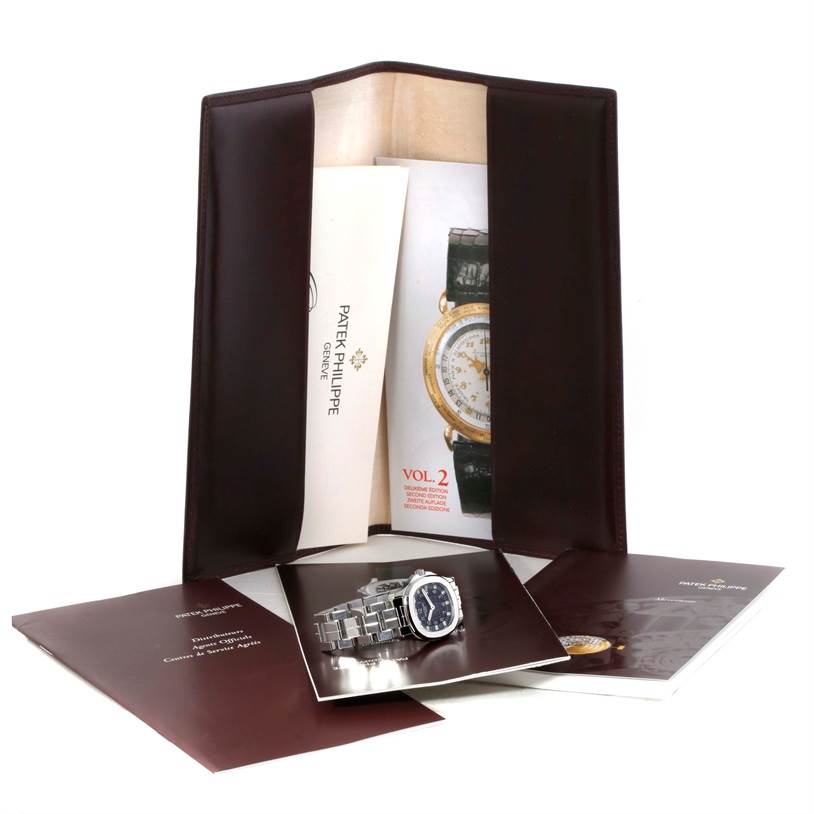 The image shows booklets and documents related to the Patek Philippe Aquanaut 4960/1A-001 Women's Stainless Steel Black Dial 4960/1A-001 Women's Stainless Steel Black Dial model, presented in an open leather folder.