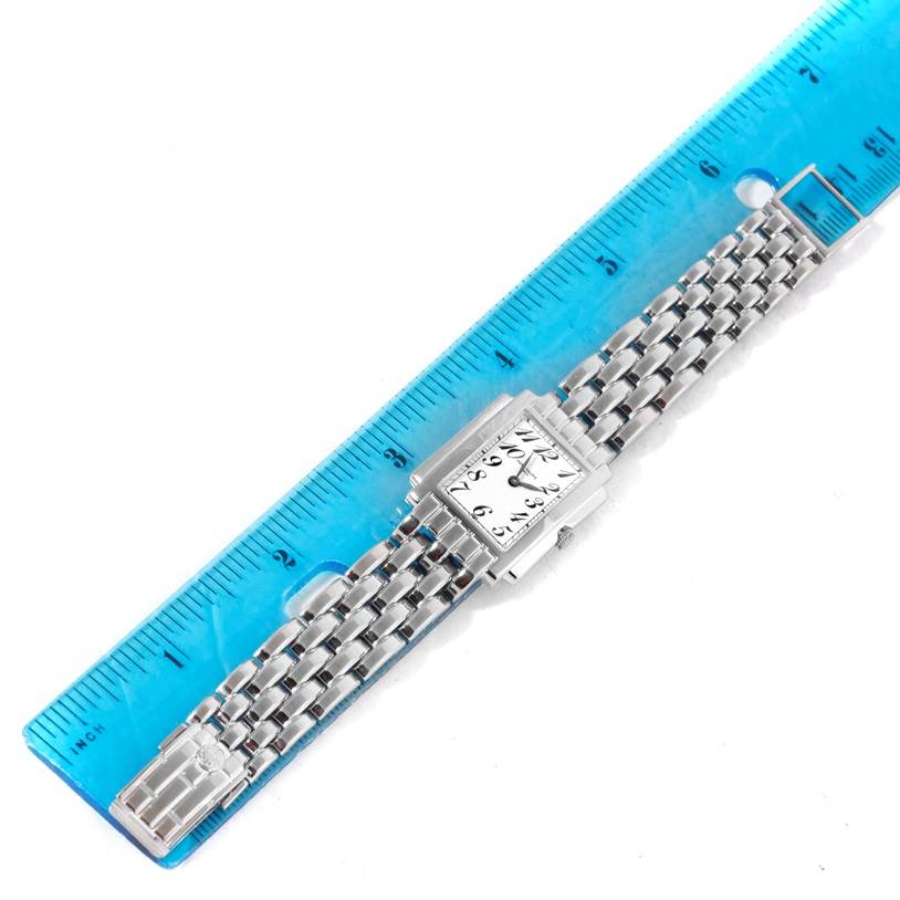 The image shows a Patek Philippe Gondolo 4824 Women's White Gold White Dial 4824 Women's White Gold White Dial watch laid flat next to a ruler, displaying its face and bracelet.