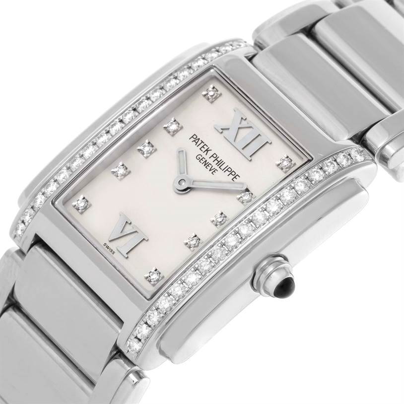 The image shows a close-up of the Patek Philippe Twenty-4 4910/10A-011 Women's Stainless Steel Silver Dial 4910/10A-011 Women's Stainless Steel Silver Dial watch face and part of its bracelet, highlighting the diamond accents and crown.