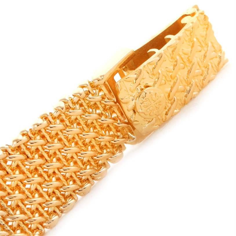 This image shows the gold clasp and part of the bracelet for a vintage Patek Philippe watch, showcasing intricate design details.