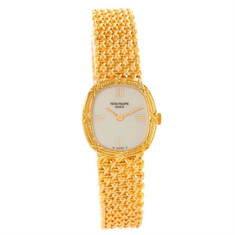 This image shows a frontal view of a Vintage Patek Philippe watch, highlighting its intricate gold bracelet and square dial.