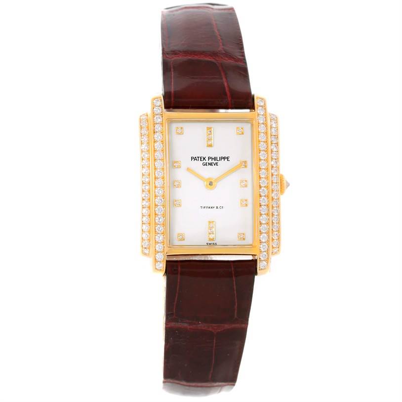The image shows a front view of a Patek Philippe Gondolo 4825/100 Women's Yellow Gold White Dial 4825/100 Women's Yellow Gold White Dial watch with a leather strap and diamond-encrusted rectangular case.