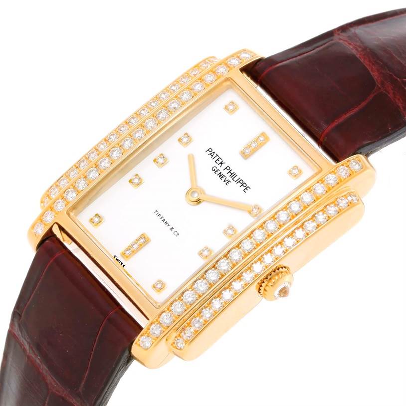 The image shows a Patek Philippe Gondolo 4825/100 Women's Yellow Gold White Dial 4825/100 Women's Yellow Gold White Dial watch from a top angle, highlighting its diamond-studded case and white dial with golden markers.