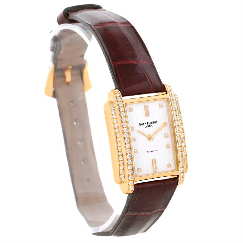 The image shows a side-front angle of the Patek Philippe Gondolo 4825/100 Women's Yellow Gold White Dial 4825/100 Women's Yellow Gold White Dial watch, highlighting the face, bezel, and strap.