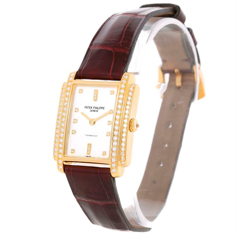 The image shows a Patek Philippe Gondolo 4825/100 Women's Yellow Gold White Dial 4825/100 Women's Yellow Gold White Dial watch angled from the front-left, highlighting the dial, bezel, and strap.