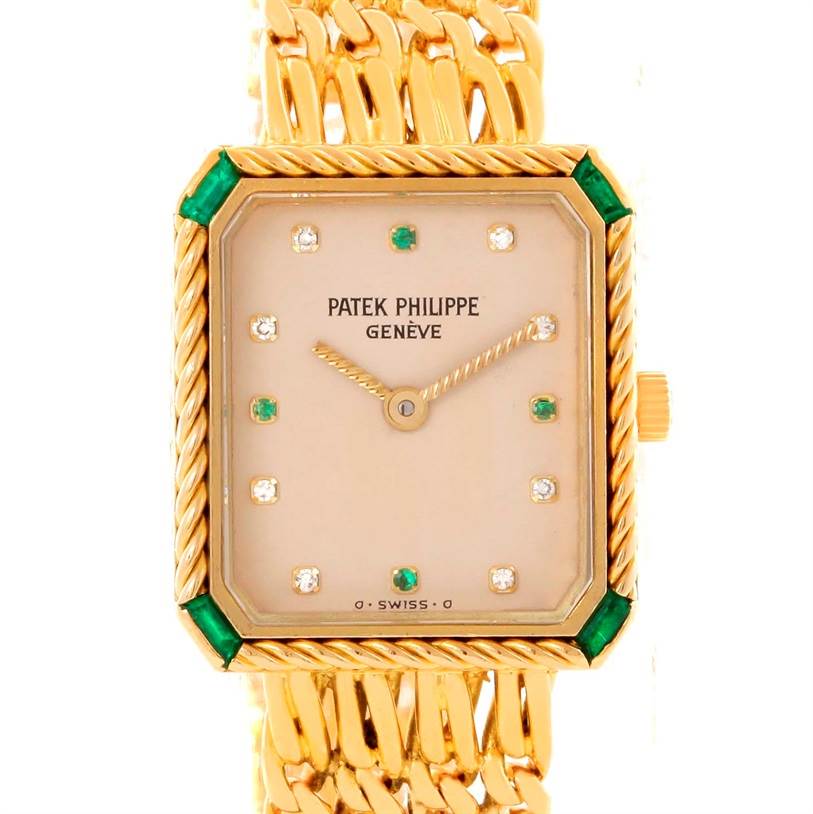 The image shows a frontal view of the Patek Philippe 4667 Women's Yellow Gold Beige Dial 4667 Women's Yellow Gold Beige Dial 4667 Ladies Watch in 18k yellow gold with diamond and emerald accents.