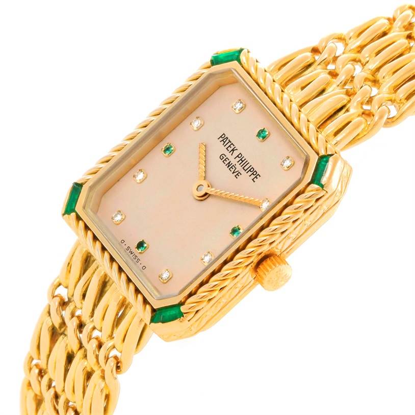 The image shows a close-up angle of the Patek Philippe 4667 Women's Yellow Gold Beige Dial 4667 Women's Yellow Gold Beige Dial 4667 Ladies Watch, highlighting its 18k yellow gold, diamond, and emerald features.
